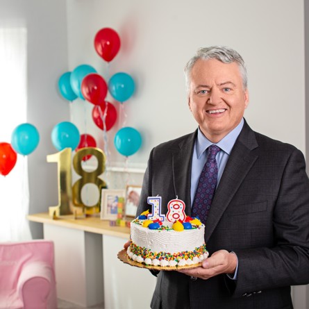 Photo of State Treasurer Curtis Loftis at a birthday celebration holding a birthday cake